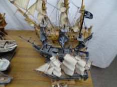 Four titled fully rigged model boats 'Endeavour', the pirate ship 'The Black Pig', 'HMS Endeavour'