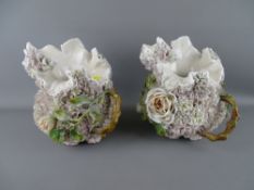 Pair of possibly German floral encrusted jugs, late 19th Century