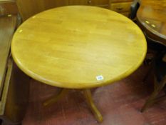 Light wood circular single pedestal table