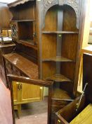 Small carved front corner cupboard with upper shelves and compact overmantel mirror
