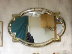 Shaped wall mirror with tiled mirrored glass and gilt pattern frame