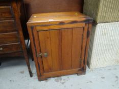 A small wooden single-door cupboard, 59 x 50 x 39cms