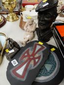 Two Celtic patterned slate wall hangings, bust of a miner's head etc