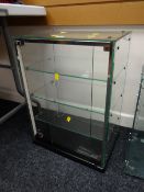 A glass sliding door & shelved counter top display cabinet by Seal