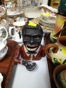 A vintage politically-incorrect painted cast money-box