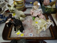 Four various ceramic figures on a lace decorated & inlaid tray