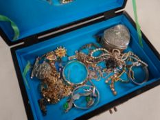 A carved stone decorated jewellery box, contents of costume jewellery possibly some silver