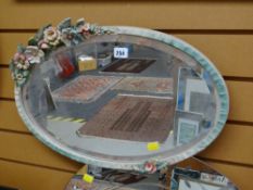 A vintage painted flower framed bevelled wall mirror