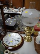 Modern circular wall clock together with a modern oil lamp