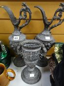 Two highly decorated pewter urns together with a twin-handled goblet