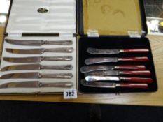 A case of hallmarked silver-handled cake knives together with a cased set of EPNS butter knives