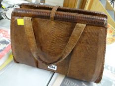 A vintage crocodile skin handbag