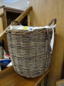 A twin-handled wicker log basket