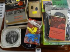 A tray of Beatles memorabilia including books, plastic figurines, pin badges & ephemera relating