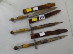 Three small decorative daggers