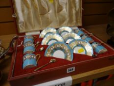 A cased Aynsley gilt & blue decorated six coffee cans & saucers