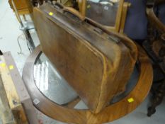 A vintage leather concertina-style suitcase