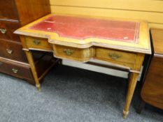 A good early twentieth century breakfront three-drawer desk with red leather tooled top, 77 x 107