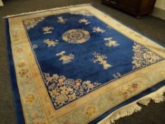 A large double knot wool Chinese patterned rug in blue & cream, 367 x 278cms