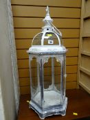 A white painted metal candle lantern