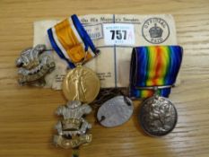 A WWI victory war medal, cap badges in the name of Crp Hughes Welsh Regiment