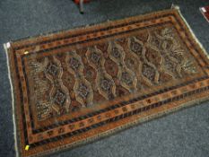 An orange & brown geometric patterned Eastern woollen rug, 163 x 96cms