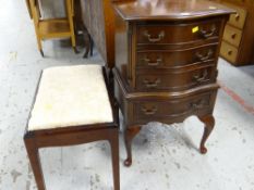 A neat reproduction mahogany four-drawer bow front chest of raised feet together with a dark wood