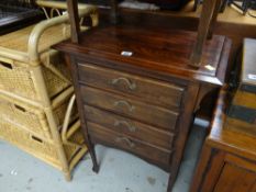 A reproduction stained pine four-drawer music cabinet, 76 x 57 x 36cms