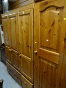 A honey pine four-door wardrobe