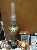 A brass oil lamp converted to electric together with a small wall mounting display case E/T