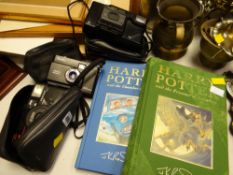 Three vintage cameras, two volumes of Harry Potter