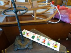 A small cast metal stick / umbrella stand together with a Seven Dwarfs coat hanger