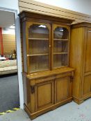 A good vintage oak glazed two-door cupboard bookcase, 198 x 121 x 47cms
