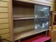 A vintage lightwood sliding door bookcase