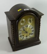 An oak cased dome top mantel clock
