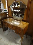 A 'Handcraft Quality' bedroom suite comprising a walnut effect dressing table, two double wardrobes