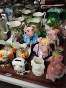 A collection of Wade Natwest piggy banks, other piggy banks & decorated jugs