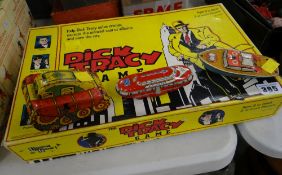 A vintage Dick Tracy boxed game & three vintage child's metal toy vehicles