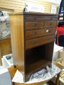 A reproduction mahogany small chest with open base & slide drawer