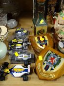 Collection of Formula One racing cars, military wall shields etc