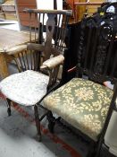 A dark oak Ercol-style Windsor armchair together with an antique profusely carved back hall chair