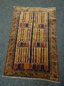 An old Baluchi rug, 128 x 85cms