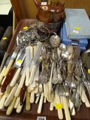A tray of various flatware, some boxed, copper kettle
