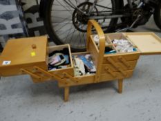 A concertina effect sewing box & contents