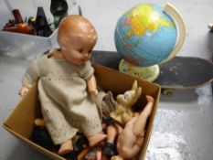 Box of various dolls & doll parts, skate board & a metal student globe