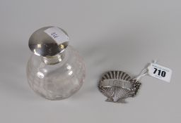 A hallmarked silver decanter label in the form of a shell together with a hallmarked silver topped
