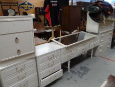 A parcel of modern white bedroom furniture including mirror dressing table, chest of drawers,