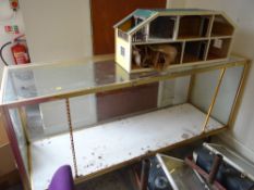 Vintage glass shop counter together with a retro beige leatherette bar / kitchen stool