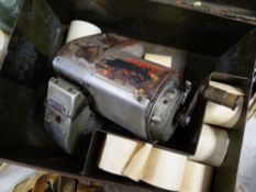 A vintage Mycalex bus ticket machine together with a selection of ticket rolls in a metal tin