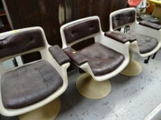 Three retro white plastic & leatherette button cushion seated swivel chairs